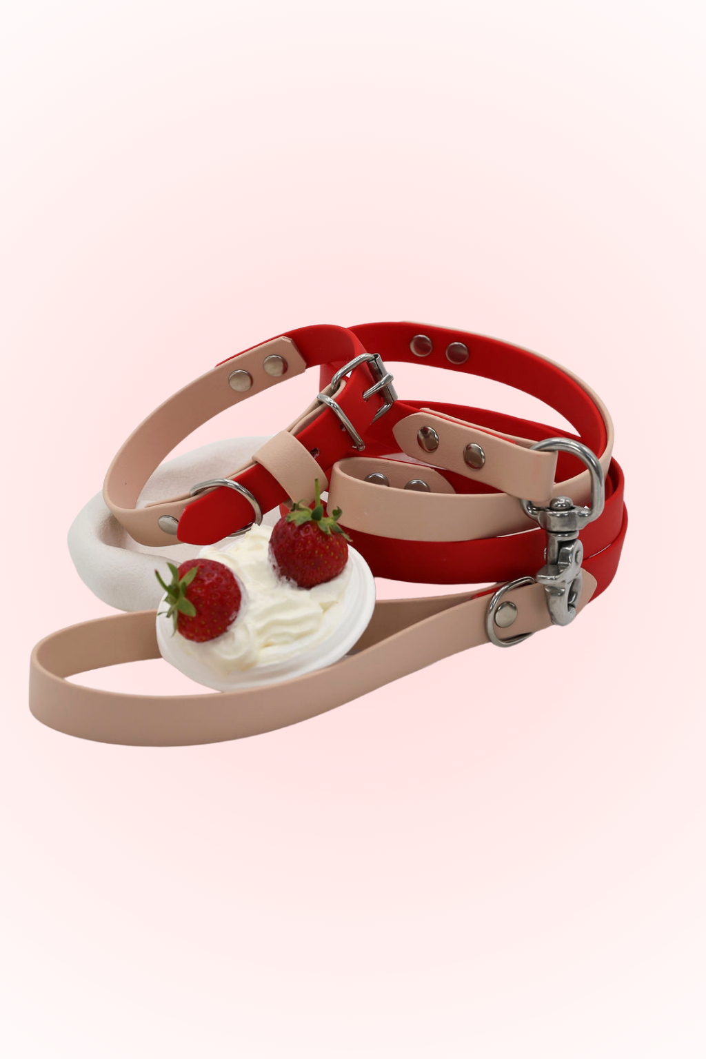 A two-tone biothane dog collar in vanilla and red cherry colors, accompanied by a matching lead, displayed against a plain background.